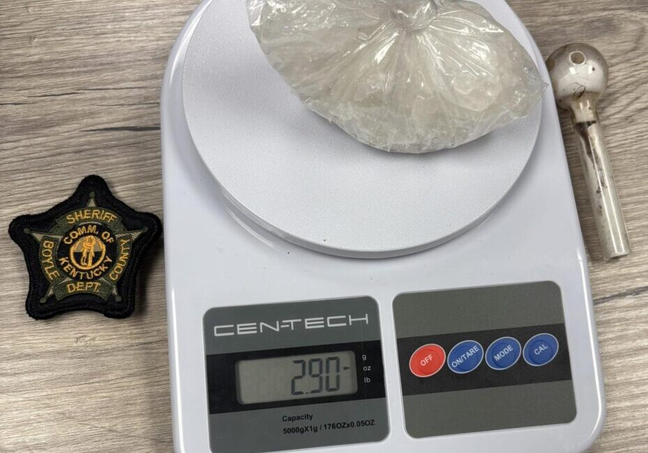 Digital scale with bag and sheriff badge.