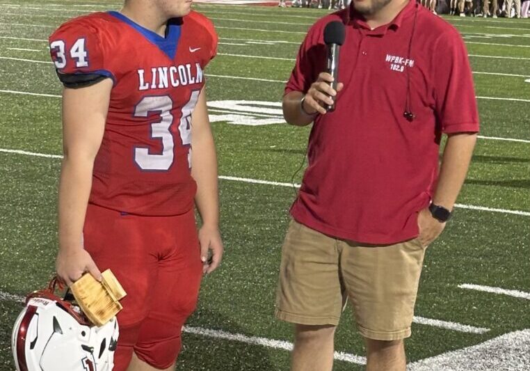 Football player interviewed on the field.