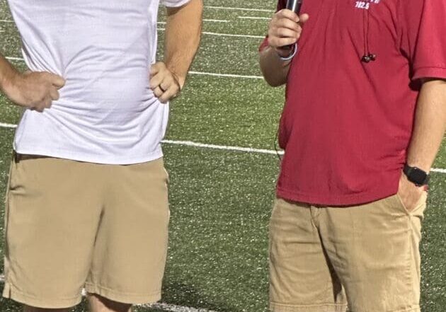 Reporter interviewing coach near sideline