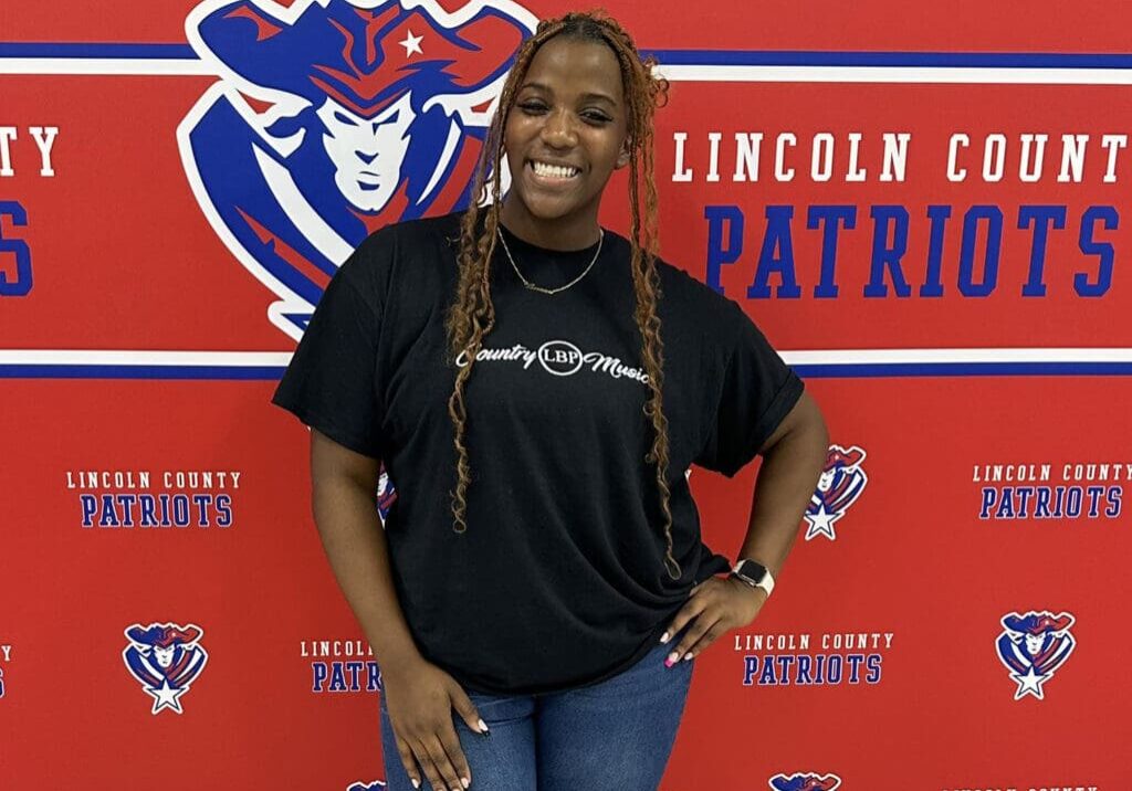 Smiling woman in front of Lincoln County backdrop.
