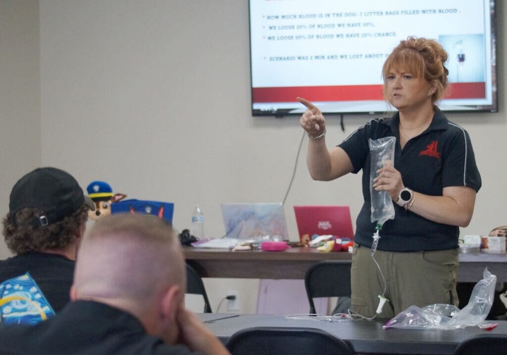Instructor demonstrating IV bag to students