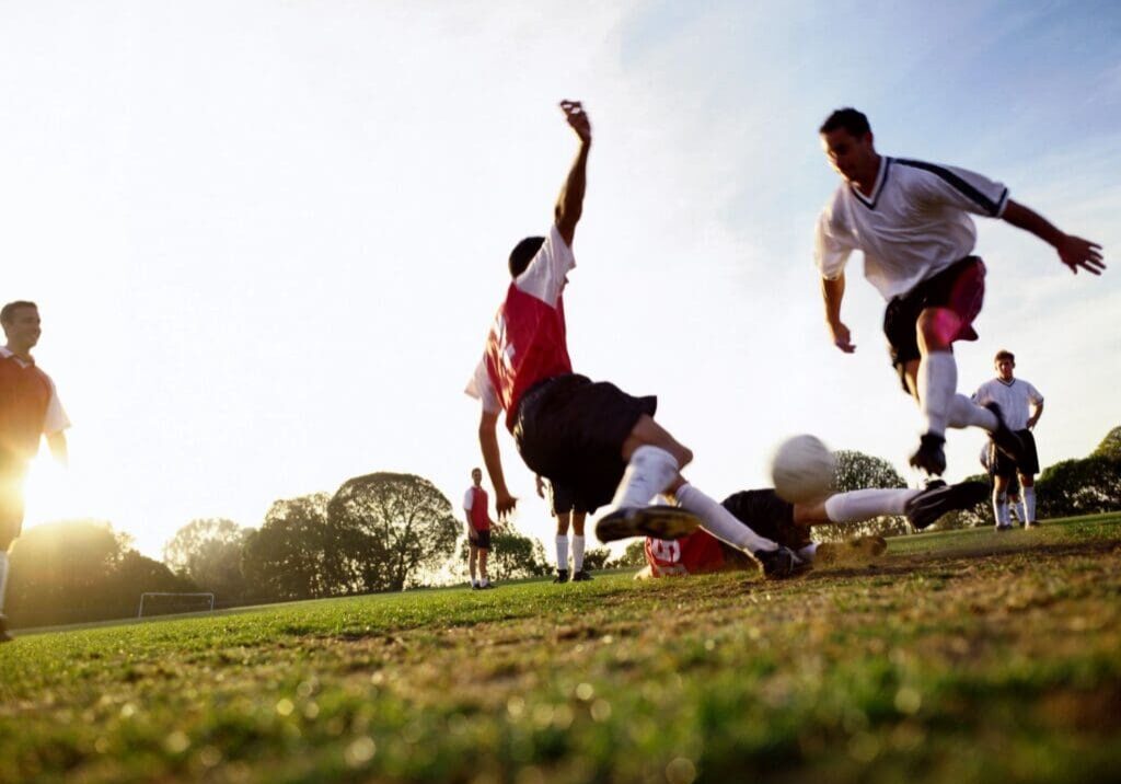 Soccer players competing on grassy field.